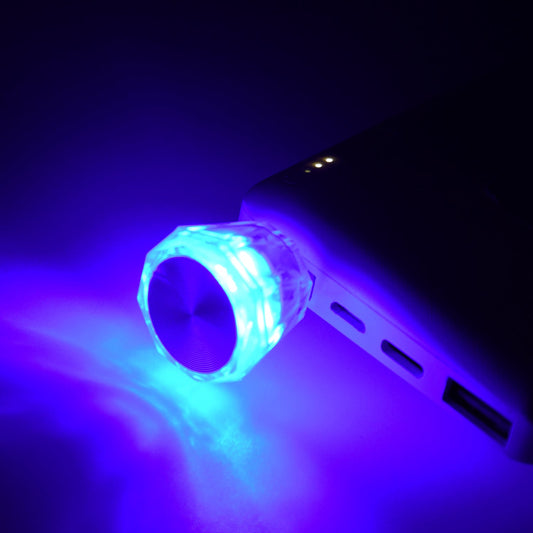 diamond shape USB car interior light glowing with mixed colors.