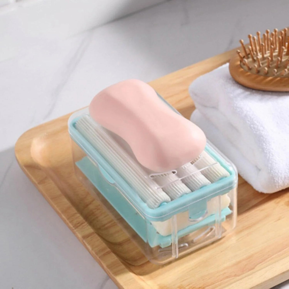 Portable detergent bar holder with a built-in roller brush, ideal for travel.