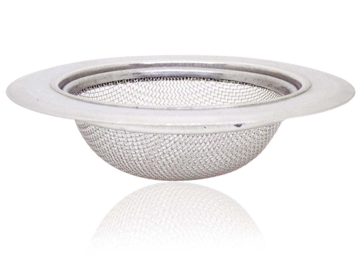 Stainless steel sink strainer seamlessly installed in a modern kitchen basin.
