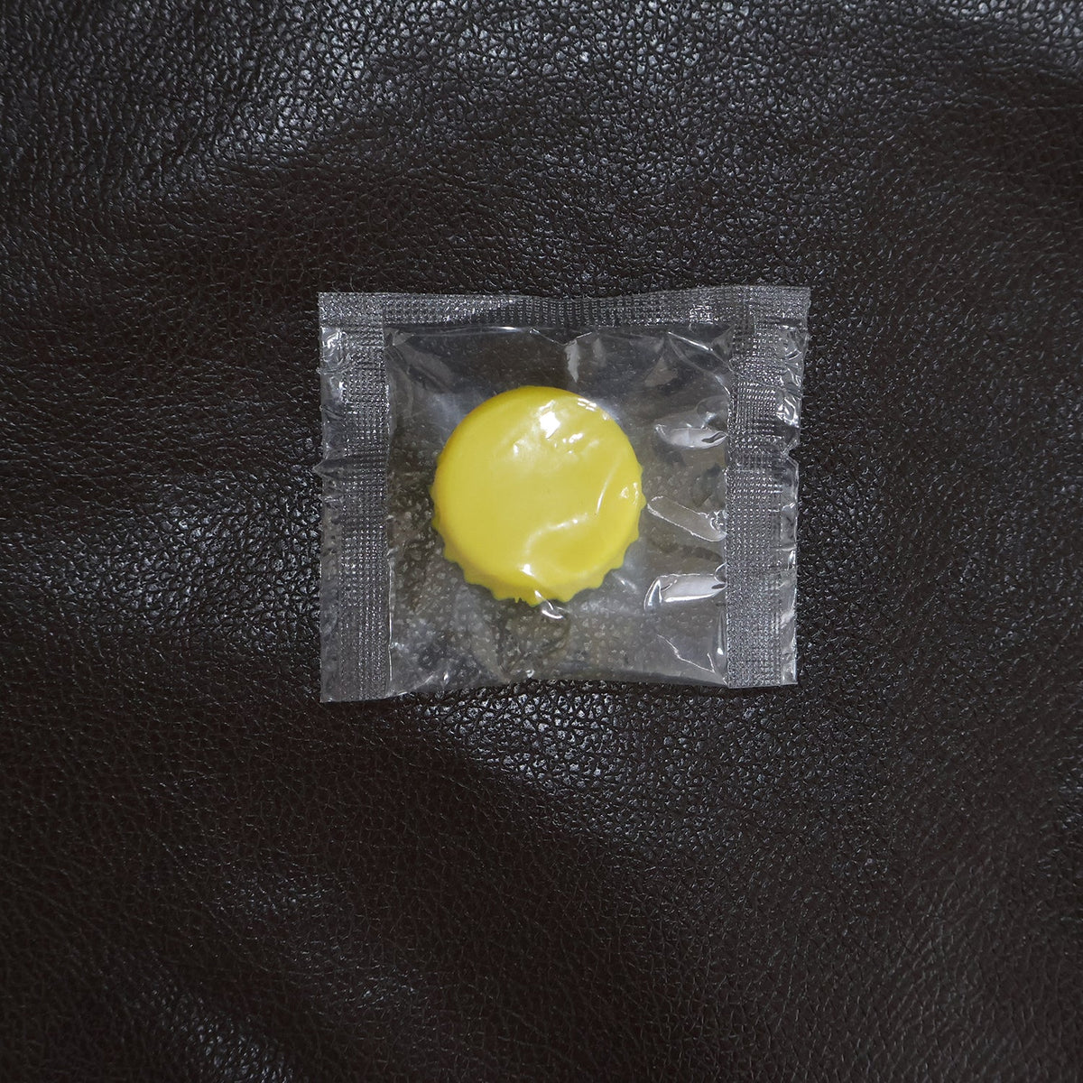 Reusable silicone bottle cap cover in use