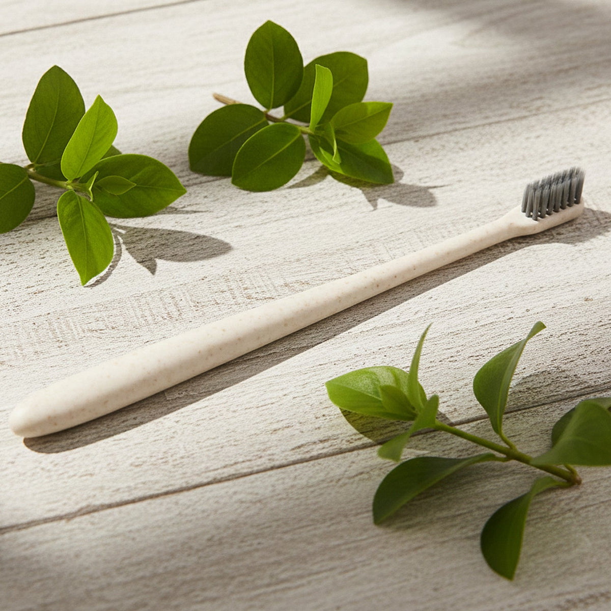 A hand holding the ergonomic MintGuard Soft-bristle Toothbrush for comfortable and precise grip.